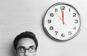 man looking at a clock in black and white