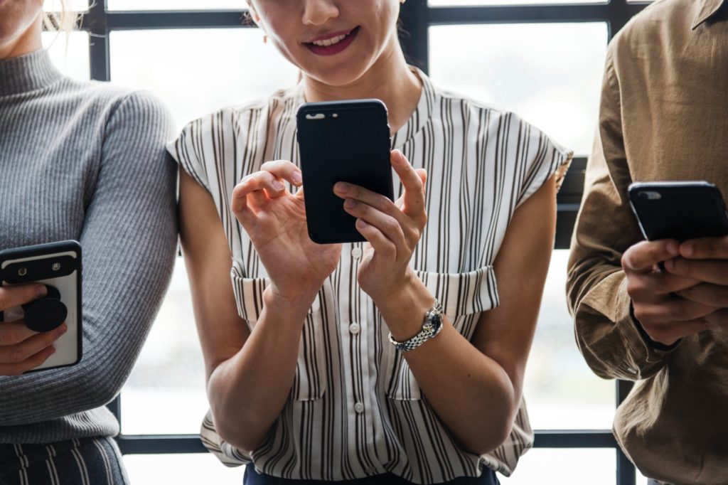 smiling girl holding a cell phone 