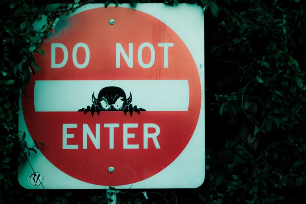 do not enter sign with evil creature painting on it