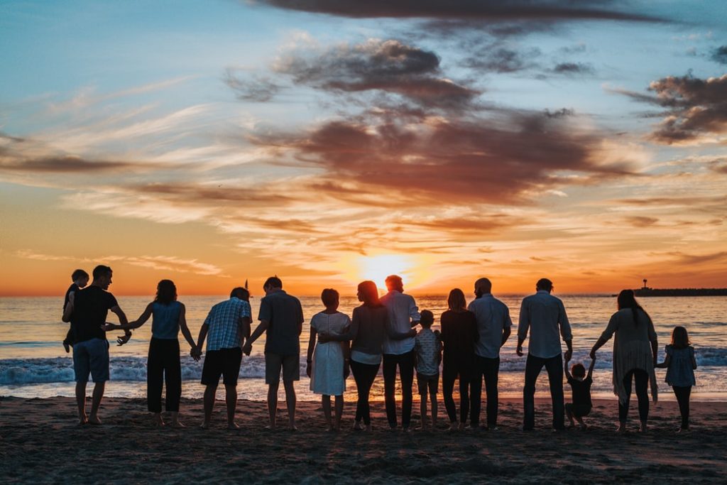 a family on the beach at sunset 