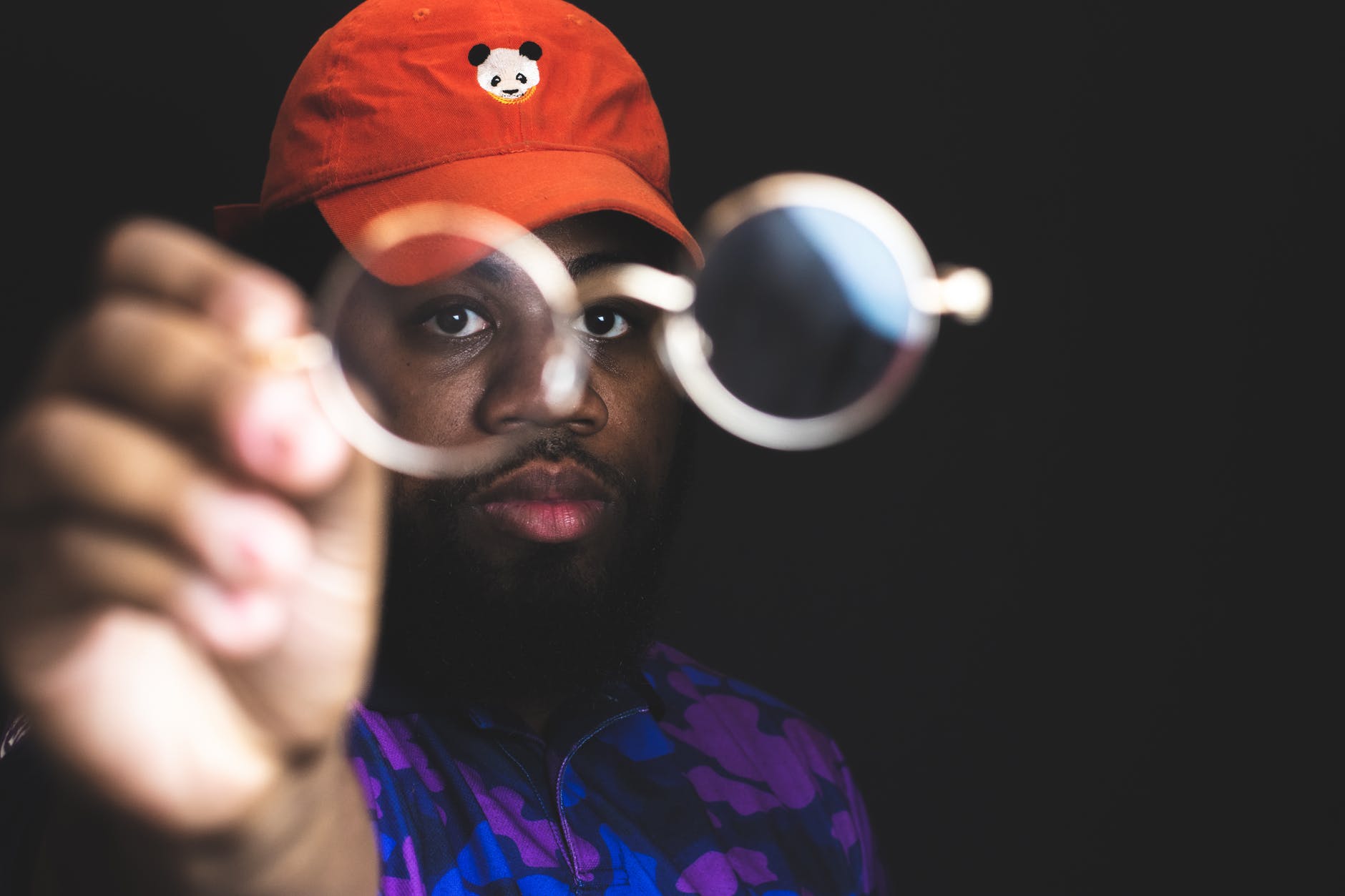 man holding up glases, focused on his eye