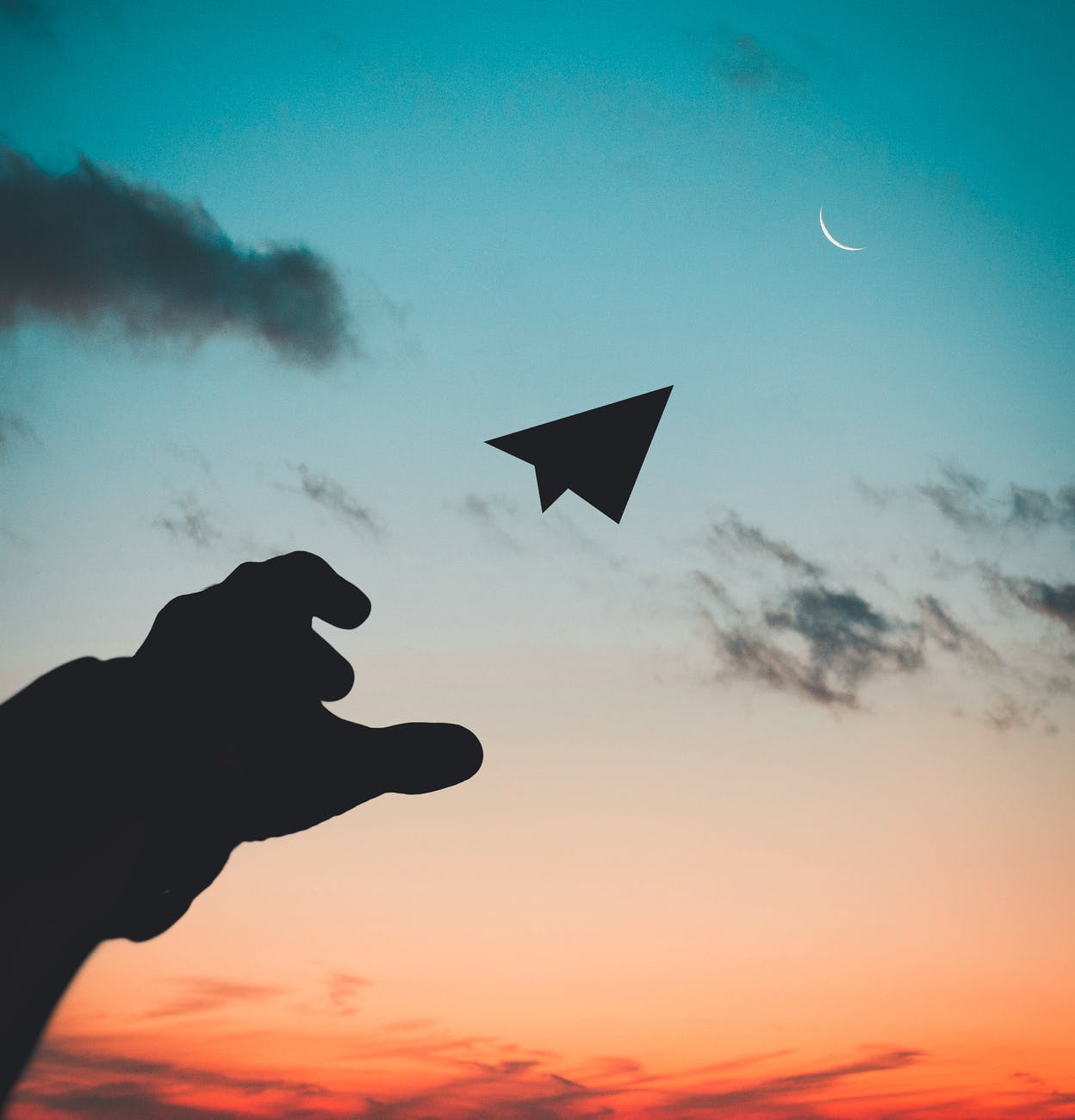 throwing a paper airplane at the sky 