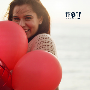 Do What You Love As Creative Marketer | A Woman Brightly Smiling While Holding A Red Balloon