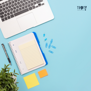 How A/B Testing works? | Top View of A workspace With Laptop Notebooks, Sticky Notes, Pen, and a Plant on the Side.