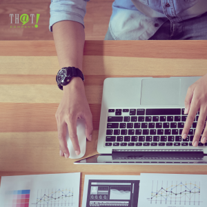 Algorithm Changes Have No Impact on PPC Ads | Top View of a Man On His Workstation With Laptop and Paper of Reports