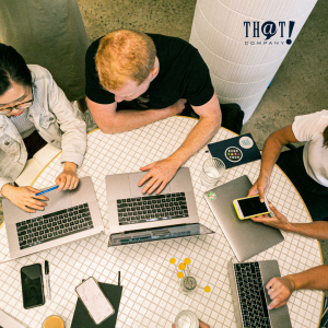 Marketing Strategies | A Group Of People Sitting On A Round Table With Their Laptops and Phones