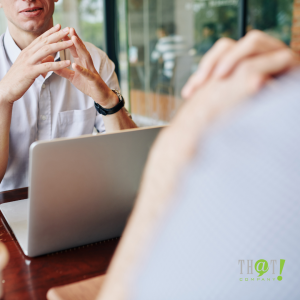 Use Positive Language | Two Man Talking Over Table With Their Laptops