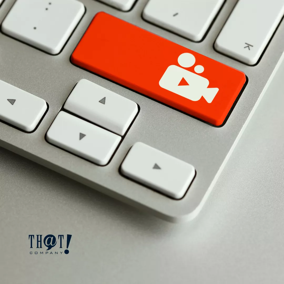 A Keyboard with A Red Video Logo On One Key