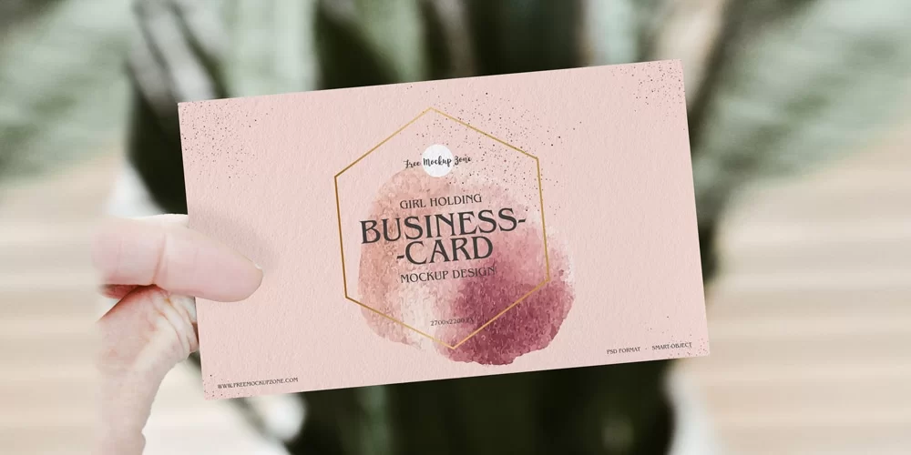 Free-Girl-Holding-Business-Card-Mockup-PSD