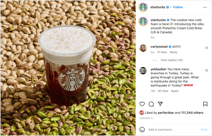 Produktaufnahme einer Tasse Pistachio Cream Cold Brew auf einem Hintergrund aus geschälten und ungeschälten Pistazien.