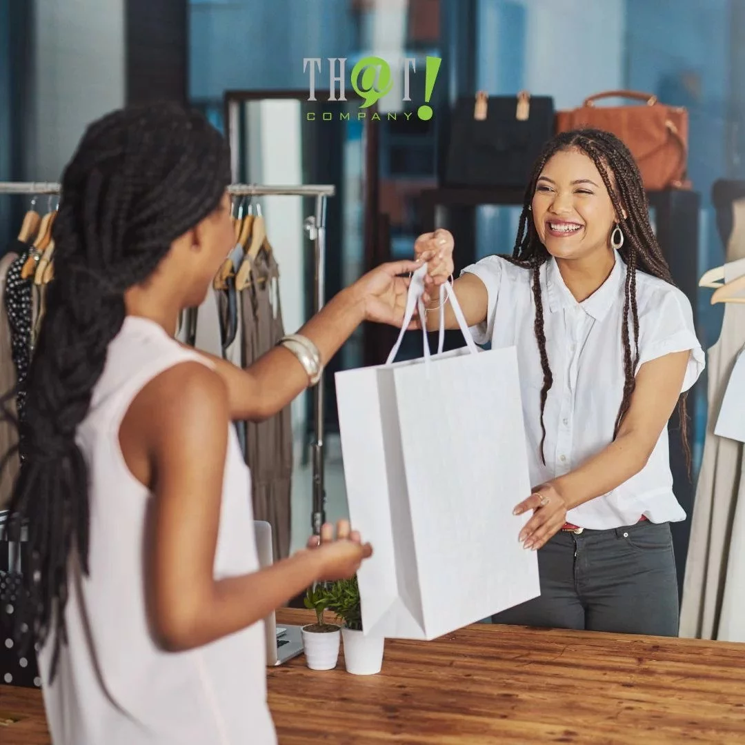 Local Businesses | A Girl Handing A Paper Bag For The Customer 