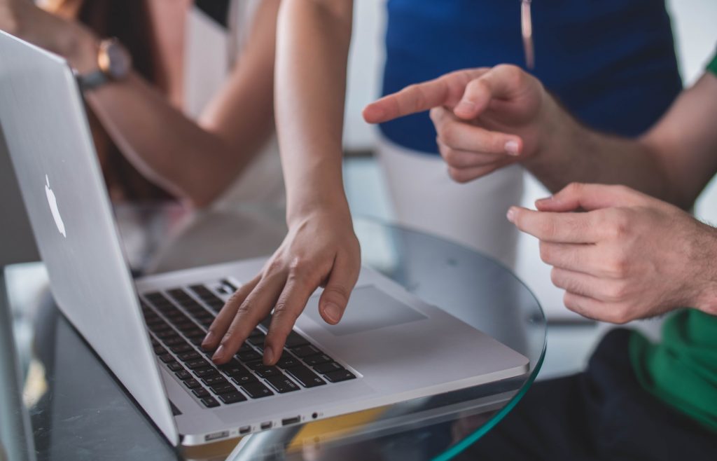 Uomo che indica lo schermo del laptop